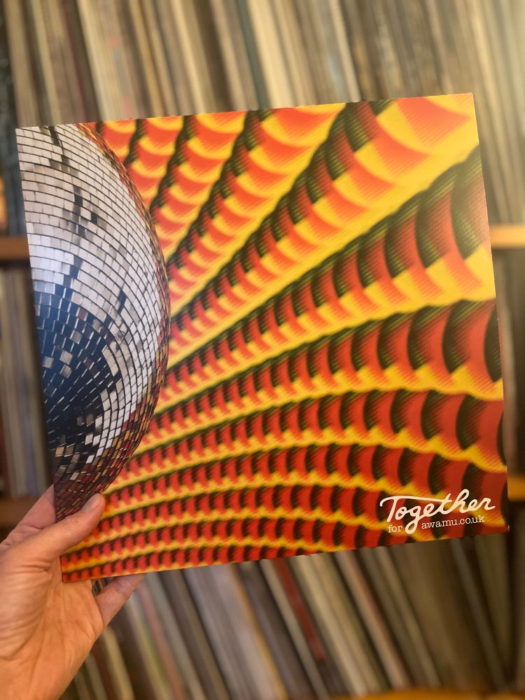 A vinyl record cover showing a glitterball against a patterned background