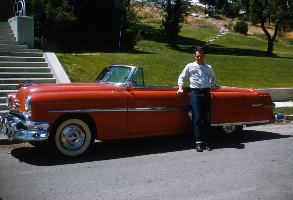 Man posing with a Ford 