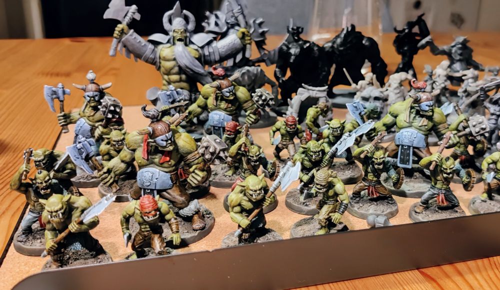 20 smaller Grubbers (green orcs with melee weapons) with four larger Muckers mixed in. In the back a partially painted Orcneas can be seen, towering over his minions.