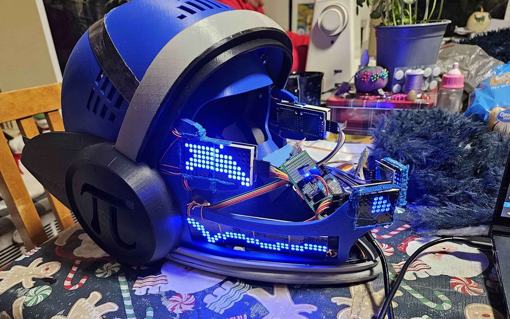 Blue LED Protogen head running with the the inner electronics exposed for firmware flashing.