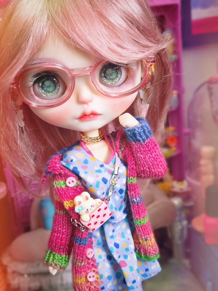 The doll looking at the camera with green eyes