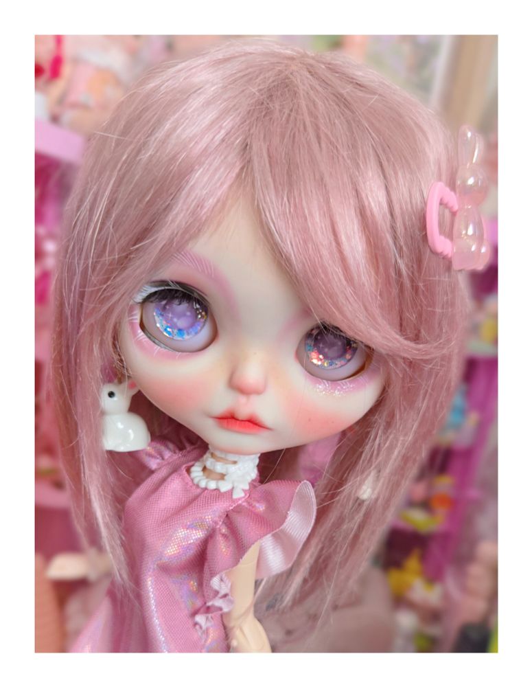 The doll with purple eyes standing in another angle