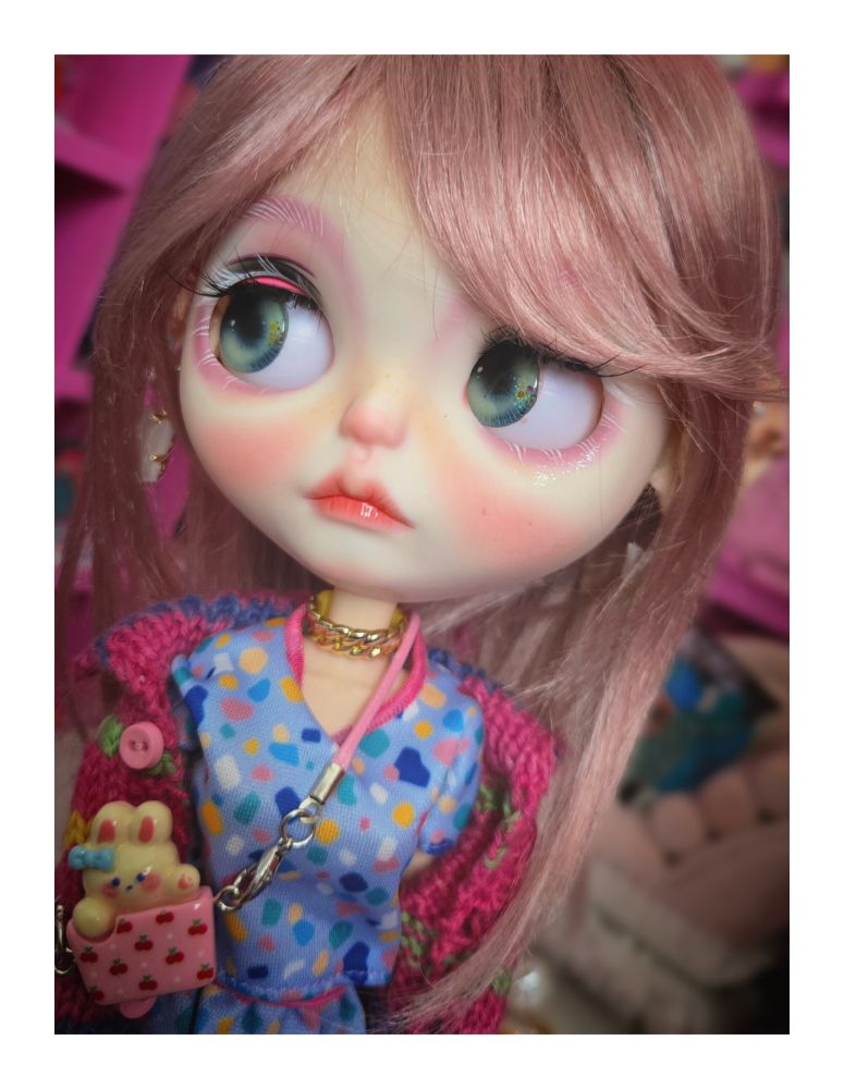 The doll looking left with green eyes