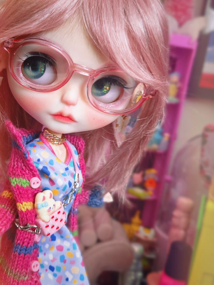 The doll looking left with green eyes