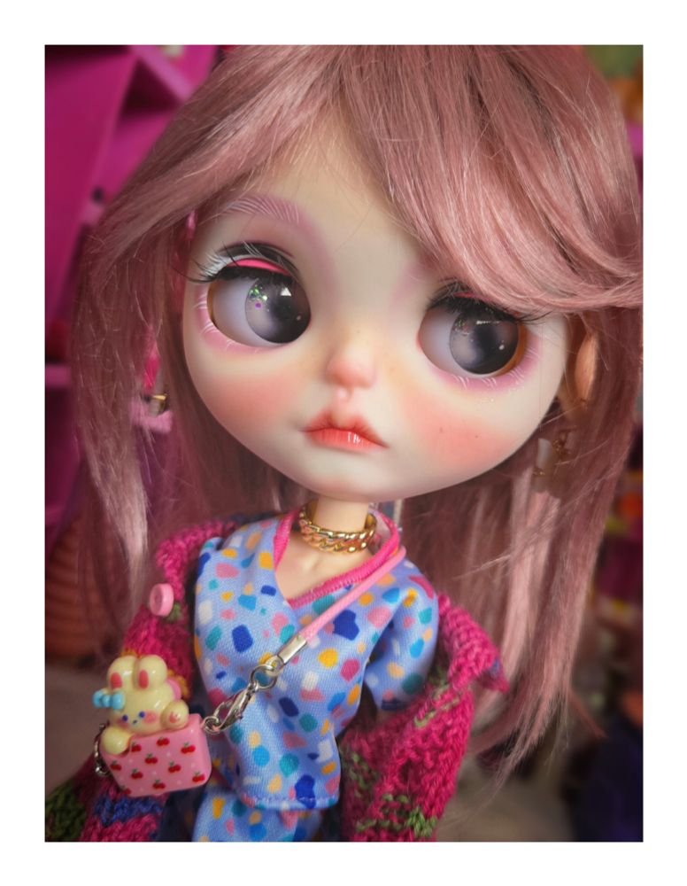 The doll looking left with purple-brown eyes