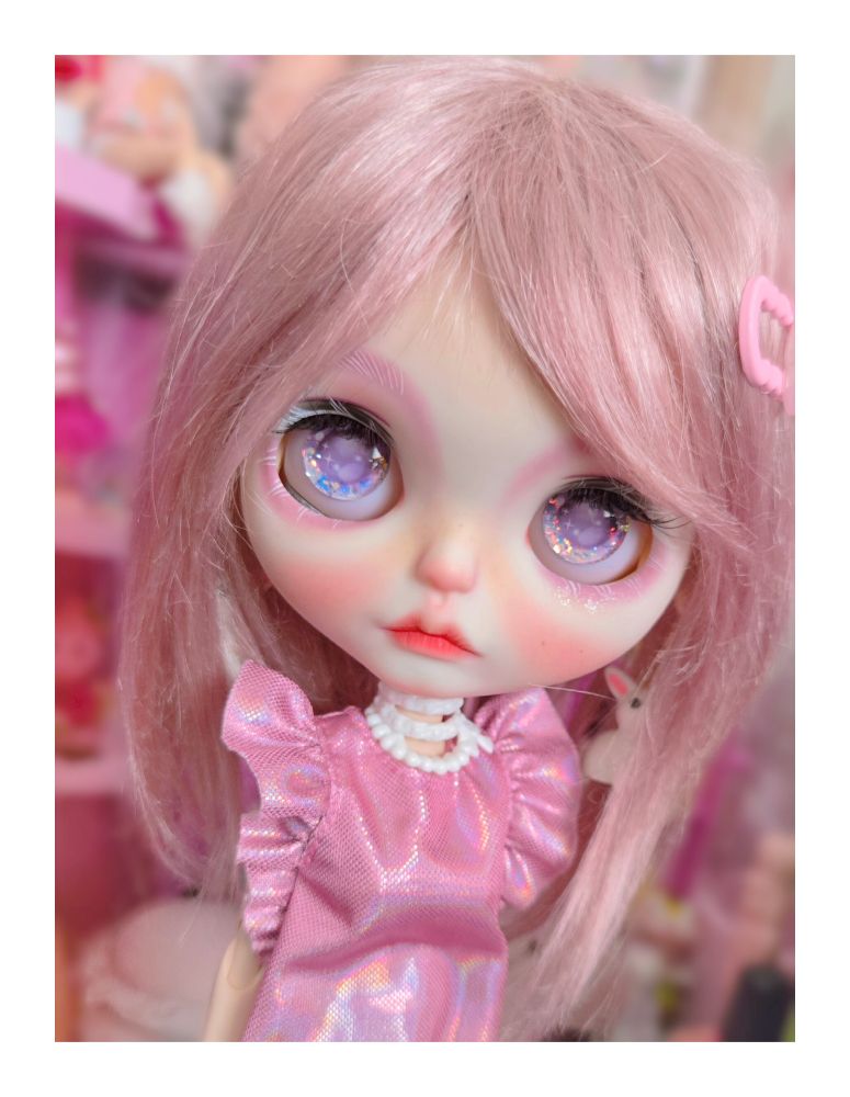 The doll looking up with purple eyes 