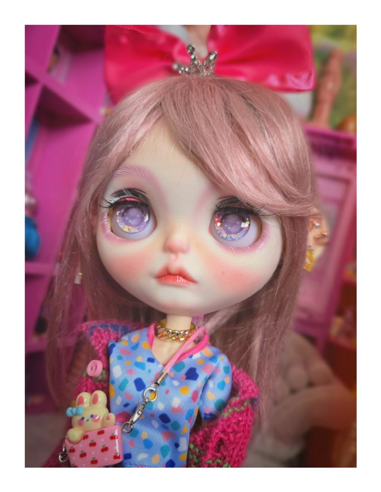 The doll looking up with purple eyes