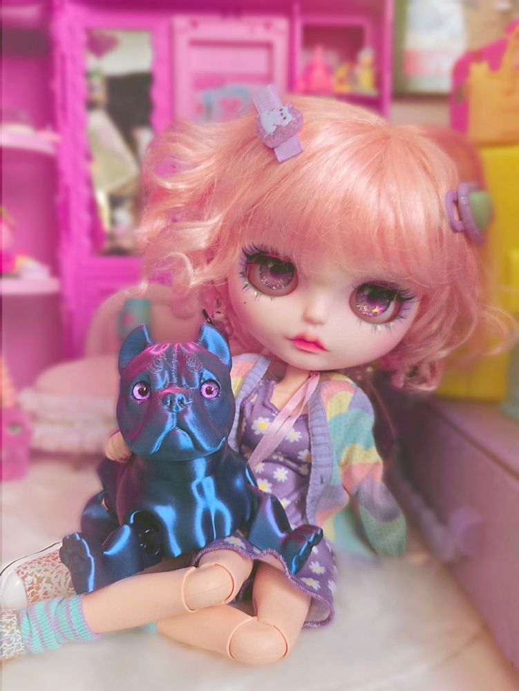 A full-body photo of the doll and her dog