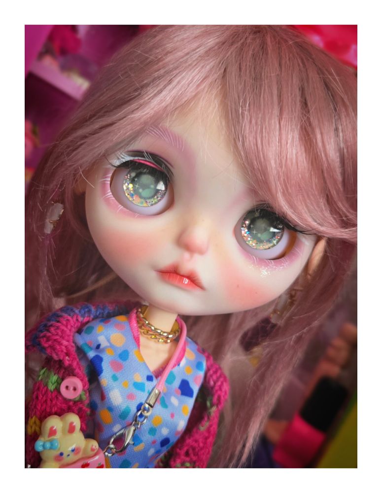 The doll looking up with green eyes