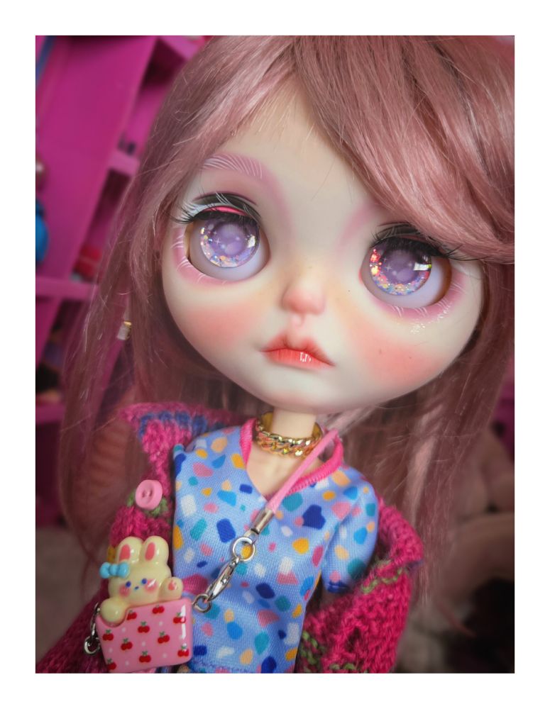 The doll looking up with purple eyes