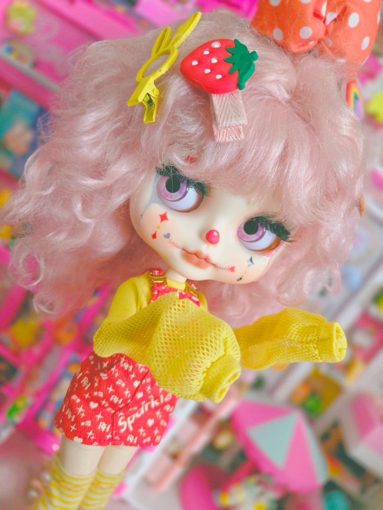 A closeup of the doll with her big sleeves