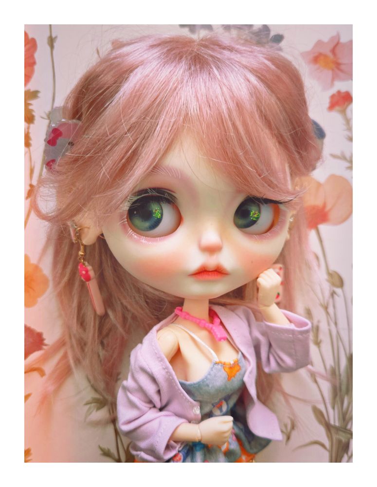 The doll looking to the right with her sweatet sliding off her shoulder