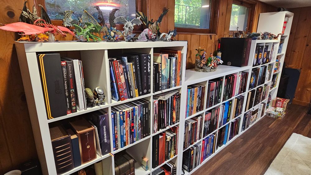 4 large shelves filled with RPGs and boardgames. 