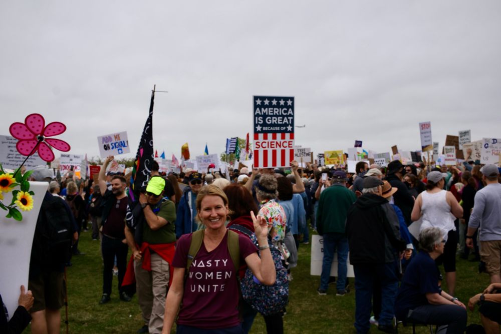 “America is great because of science” poster at #HandsOff rally in DC 2025.