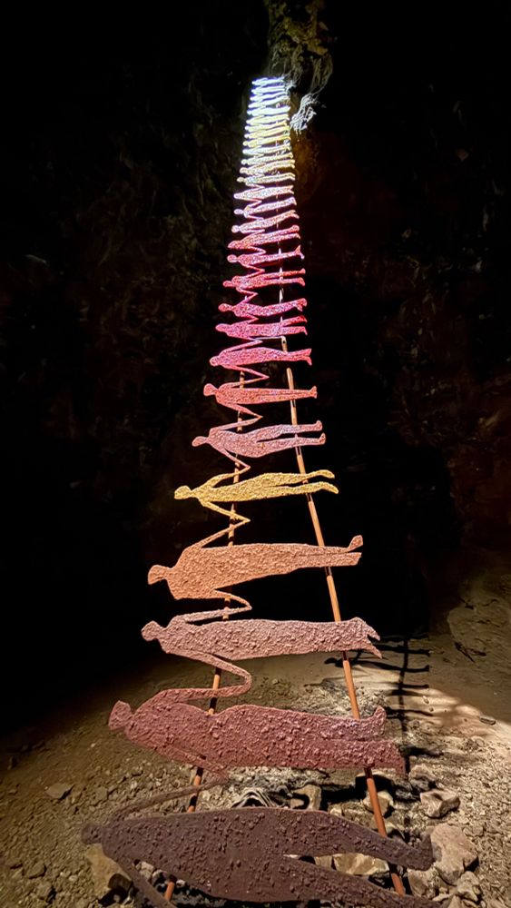 Sculpture of people holding hands in the shape of ladder 