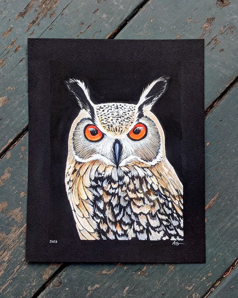 A watercolor painting of an Eagle Owl with light brown feathers and orange eyes, painted on a black background.