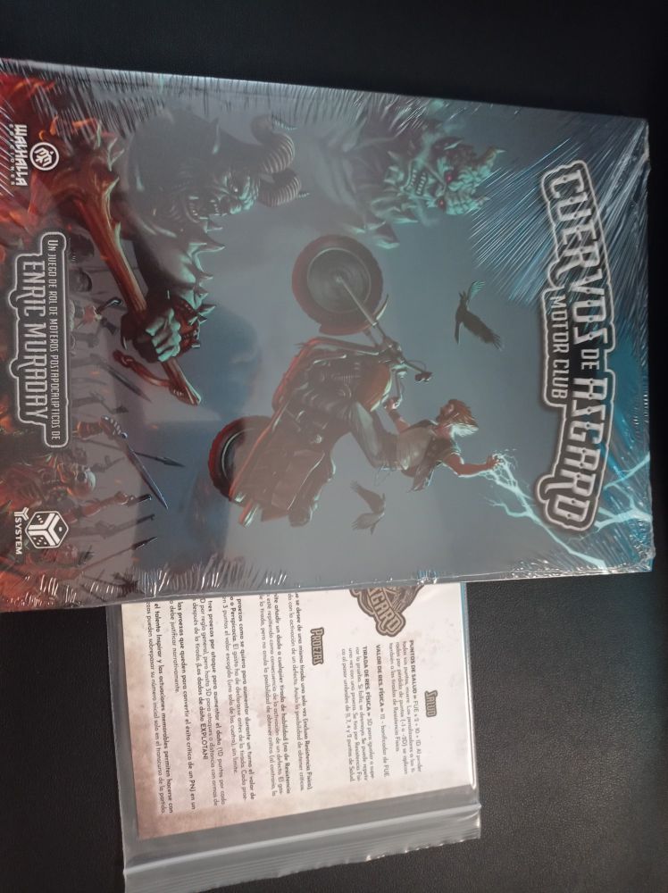 Portada del juego de rol "Cuervos de Asgard". Muestra un motero cargando con su moto hacia unas criaturas demoníacas. 