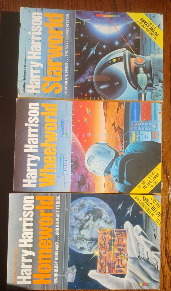 Three books by Harry Harrison badly photographed. Homeworld, Wheelworld and Starworld.