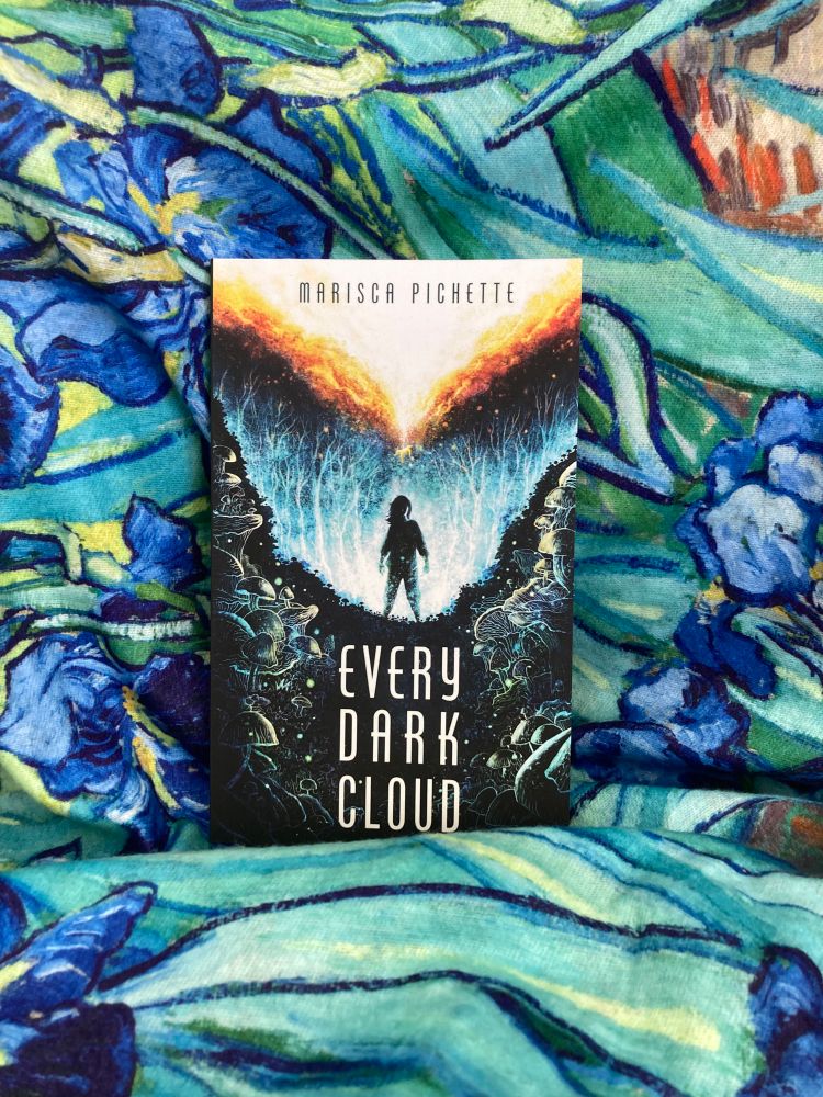 Photo of EVERY DARK CLOUD standing on scarf with design featuring Van Gogh’s iris painting.