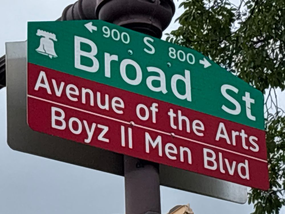 a sign for broad street in south philadelphia, which has been named both “avenue of the arts” and “boyz ii men blvd”