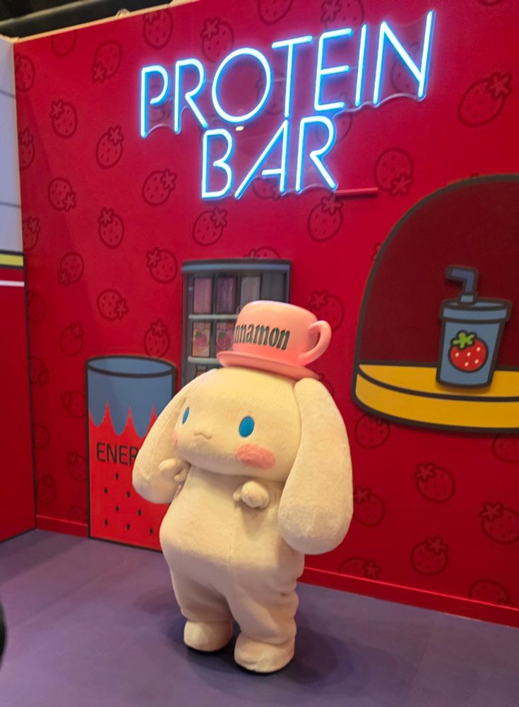 Cinnamoroll waving under a neon Protein Bar sign