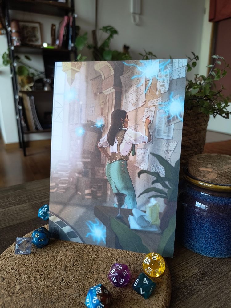 A photo of an A5 print of my Neve artwork. It depicts Neve Gallus from Dragon Age the Veilguard, standing before the wall in her room in the Lighthouse, studying the notes that are stuck to it. She is surrounded by wisps.
