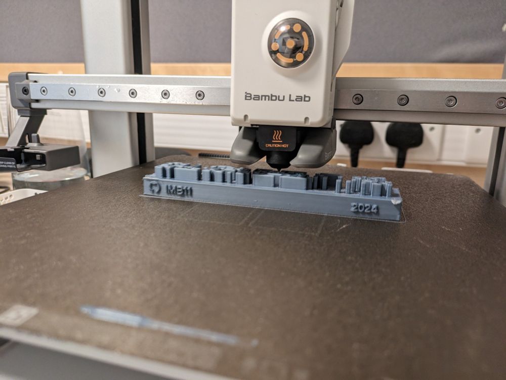 A 3D printer printing out a GitHub Contribution Graph, username IMB11, year 2024.