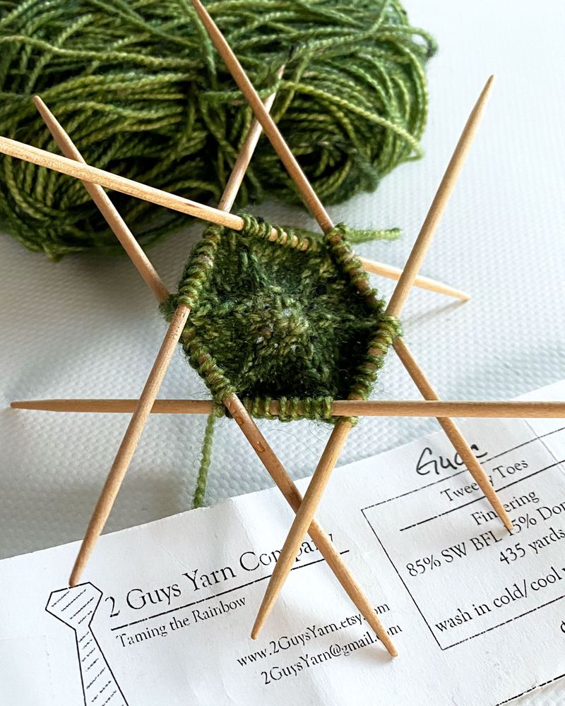 This is the start of my scrappy Musselburgh hat for Scrap Along 2025! On me, hats are uncomfortable when they inc/dec in a straight line, so that meant tinkering to increase along a curve. This center bit is Tweedy Toes from 2 Guys Yarn Company in Guac. I like everything about it! I bought the yarn in 2016 at the Madison Knitters' Guild Knit-In. Stripes come next.