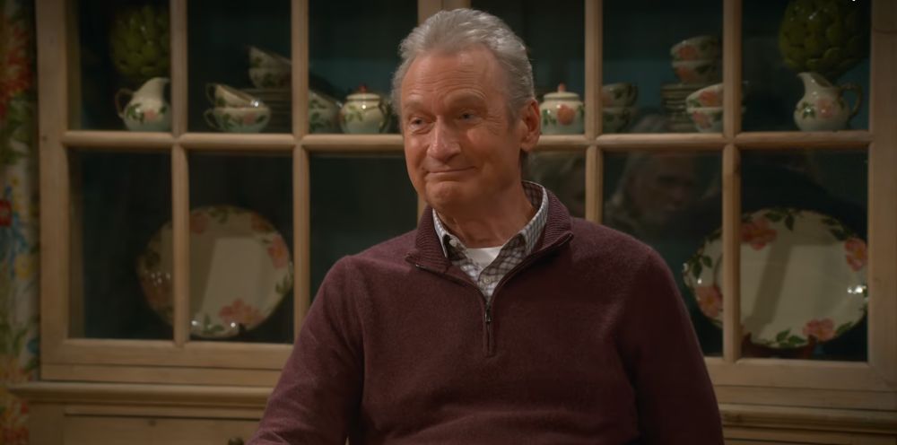 Screenshot of Ryan Stiles in front of a china cabinet