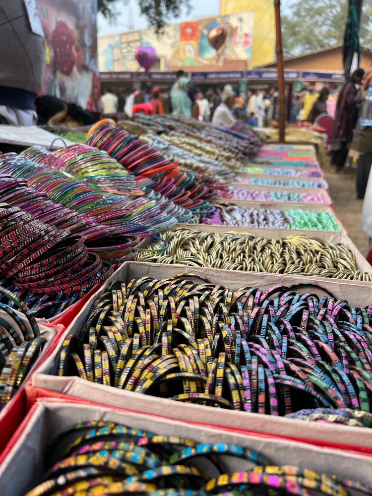 A long line of boxes with colorful bangles to wear. 