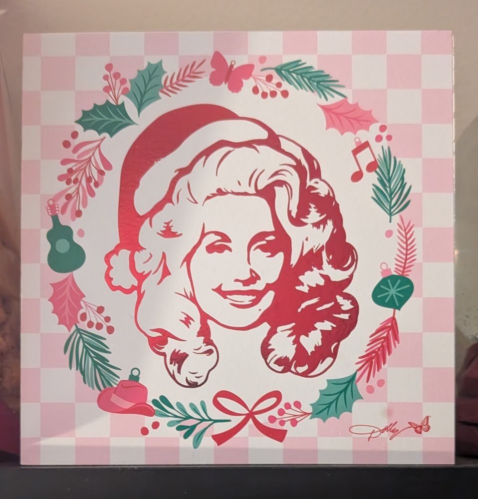A picture of Dolly Parton in a Santa hat 