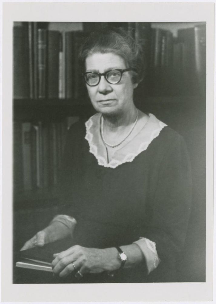 Virginia Kneeland Frantz seated with book in hand