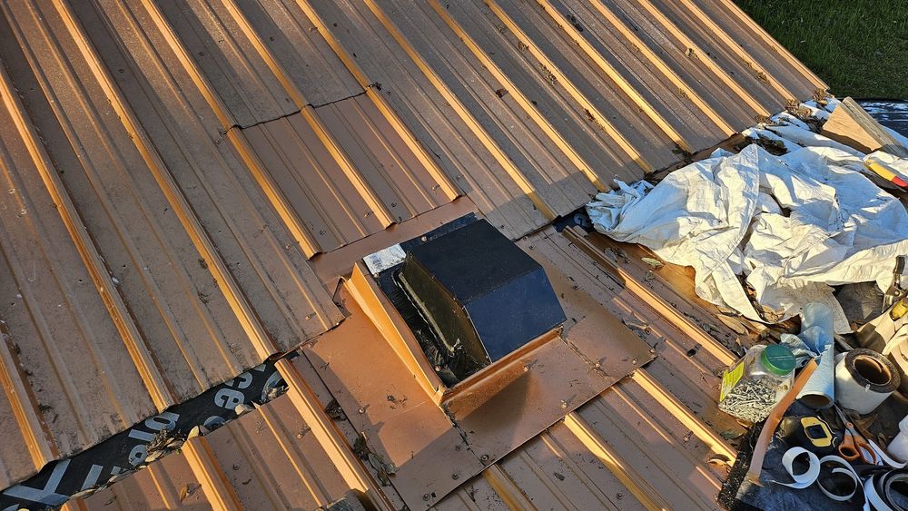 A copper-colored metal roof with a very complicated system of flashing installed.