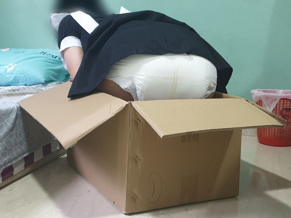 That lioxy maid sitting in a cardboard box, with their diaper butt in clear view