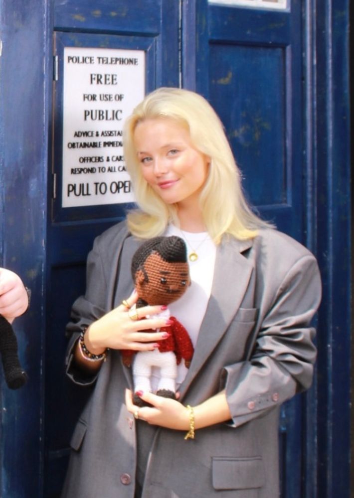 Millie Gibson holds a 15th Doctor Doll 