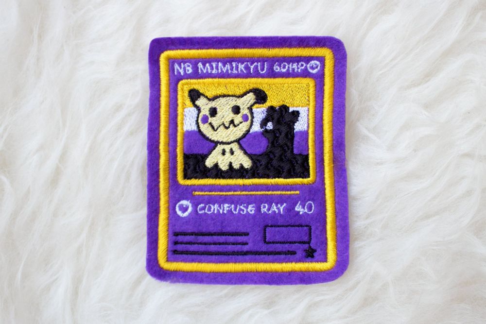 Nb mimikyu pokemon card parch text reads: nb mimikyu confuse ray 40, now with a mimikyu rainbow card next to it