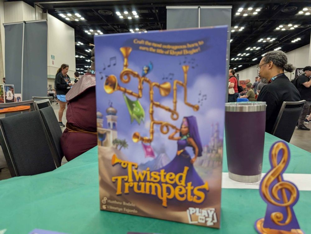 Twisted Trumpets box on a demo table at GenCon.