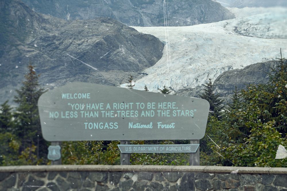 (Illustration/collage) Sign in front of glacier: Welcome "You have a right to be here, no less than the trees and the stars" Tongass National Forest
