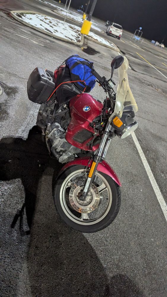 My motorcycle, Willa, parked in the cold Walmart parking lot. Although she stands again, her heart is not beating. I hope I didn't lay her down to die in this icy parking lot last night.