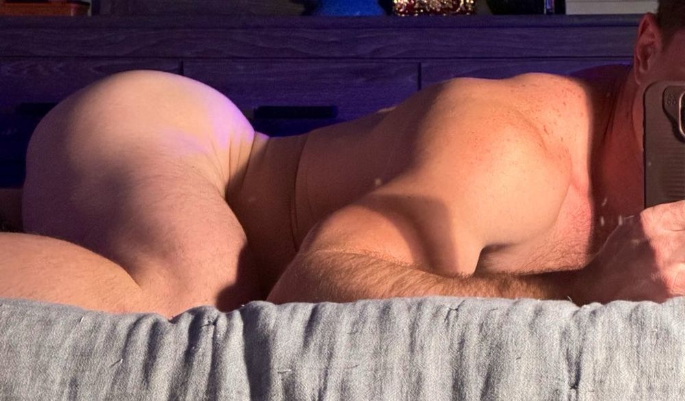 Naked man, side profile. 
Ass up, and arched in moody lighting. 