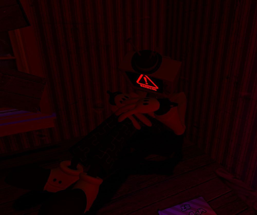 Mr. Puzzles is sitting in a corner with his knees to his chest and hands on his legs, a warning symbol on his head. A #1 Mr. Puzzles flag can be seen to the side.