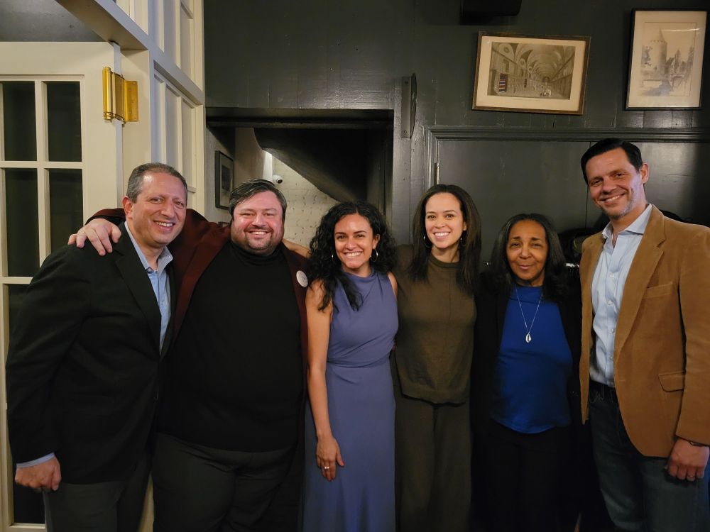 Club members and political candidates at winter celebration. Three men and tthree women against a black background