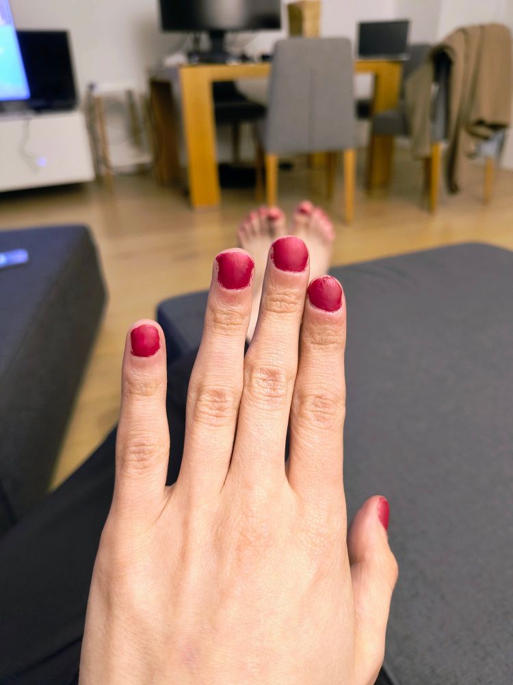 Red painted nails on the left hand
(Poorly)