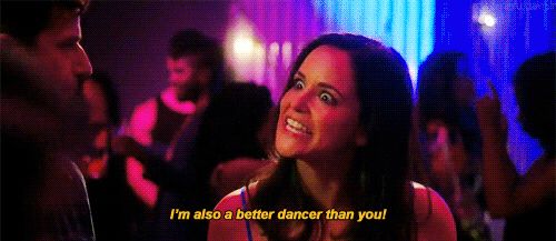 Picture of Amy Santiago (Brooklyn 99 character), baring her teeth and eyes wide, telling her brother (not pictured), “I’m also a better dancer than you!”