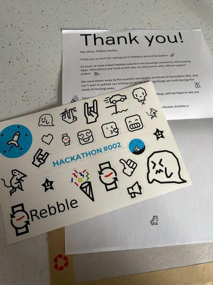A photo of rebble hackathon stickers and a thank you note 