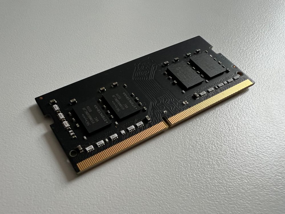 A photo of a stick of RAM with a black PCB