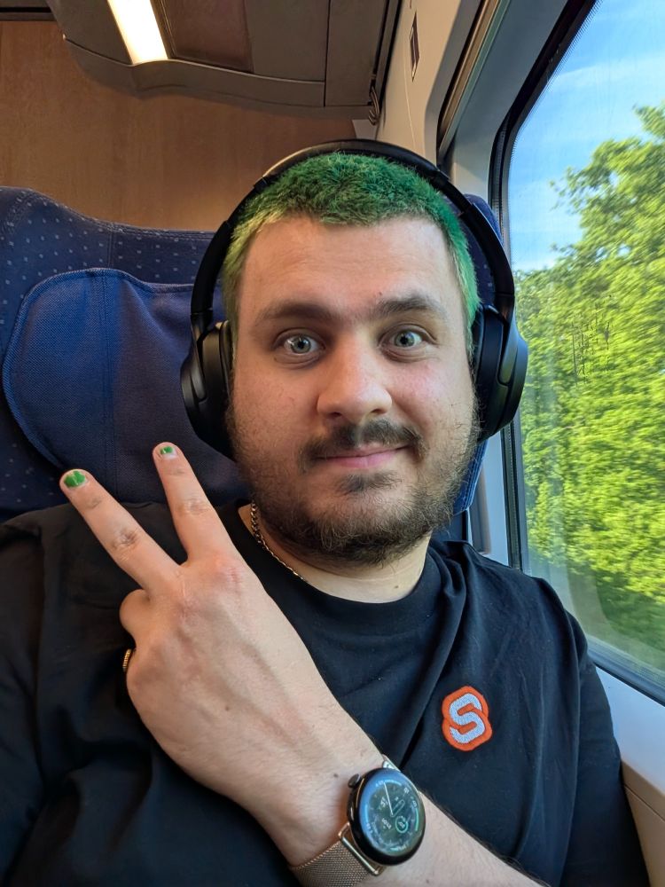 Selfie of me sitting on the train back home, throwing a peace sign and rocking my fresh new svelte t-shirt 