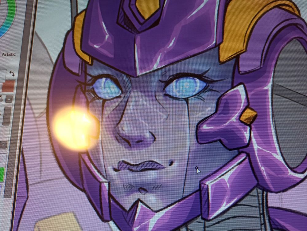 A photo taken of a screen, it's slightly pixelated and reflecting light. On the screen is an art program with a work-in-progress drawing of Nautica from Transformers opened. Only her head is visible, in 3/4 view, facing the left. Her eyes are blue and directed at the camera. Her gray face and her purple parts are shaded, but everything else is still flatt colours.