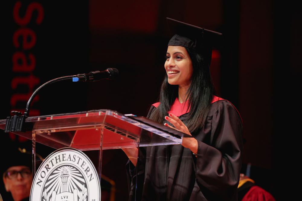 A student stands at a podium to deliver a speech.