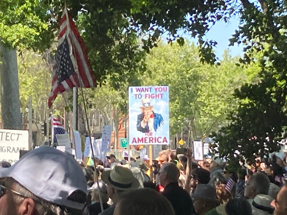 Protest sign with image of Uncle Sam pointing and saying “I want you to fight for America”